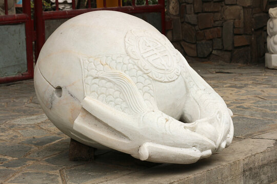 White marble wooden fish slit drum sculpture, traditional muyu percussion instrument for zen meditation chanting pattern