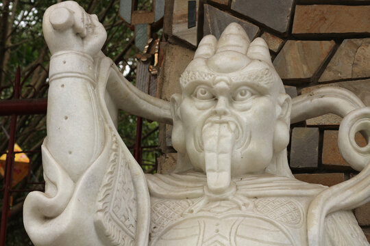 White marble temple guardian sculpture, traditional oriental protector statue of wrathful deity with sacred mythology background