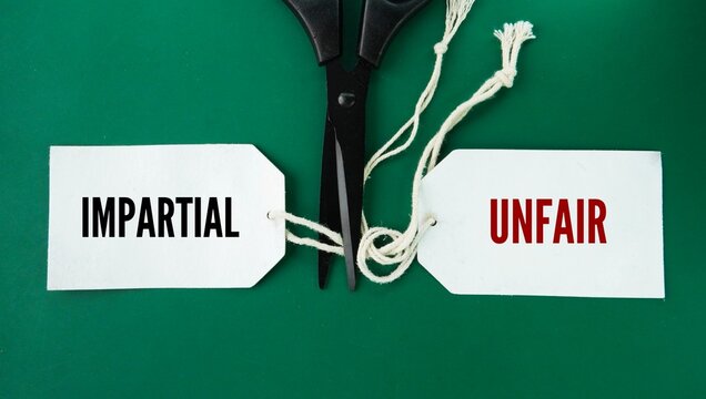 Scissors with two separated words unfair and impartial. treating everyone honestly and equally without showing favoritism, bias, or prejudice towards any side.