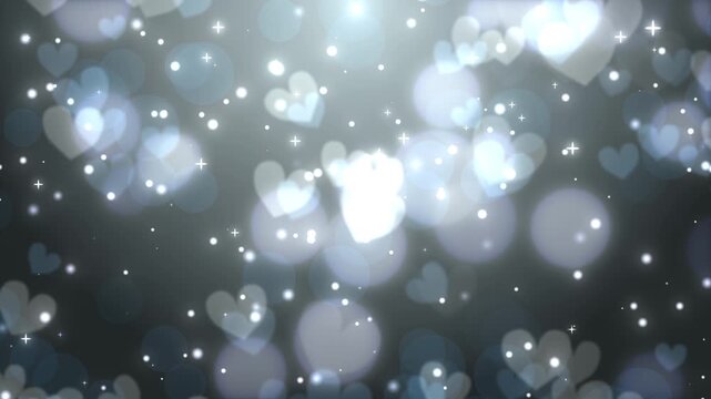 ダークシルバー背景に舞い散るハート型のボケとキラキラ輝く光のシームレスループ動画素材 / Glowing heart bokeh and sparkling light loop on dark silver gradient background