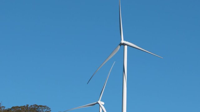 Wind Turbines Rotating Against a Clear Blue Sky in Australia