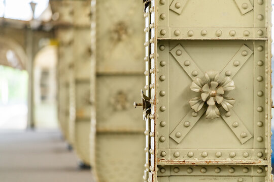 Vintage metal pillar with decorative flower and rivets .