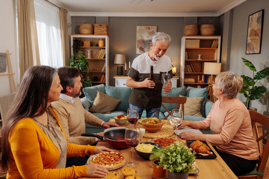 Senior friends enjoying dinner party at home