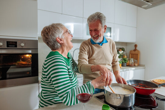 Senior couple enjoying cooking together in modern kitchen