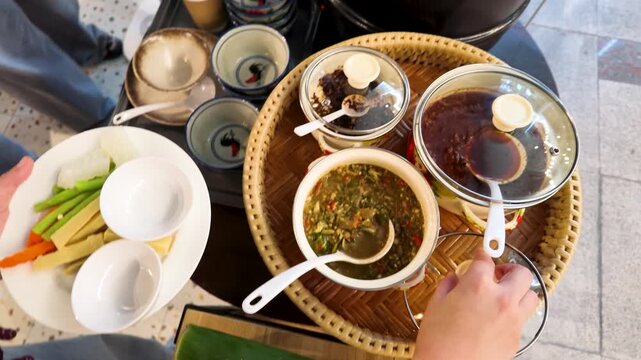 Serving Traditional Southeast Asian Dips and Fresh Vegetables from Wicker Tray