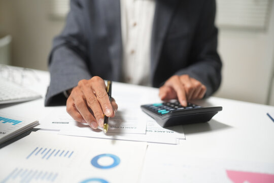 Businessman Calculating Finance and Writing Check