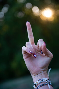 Female hand showing middle finger with nail art