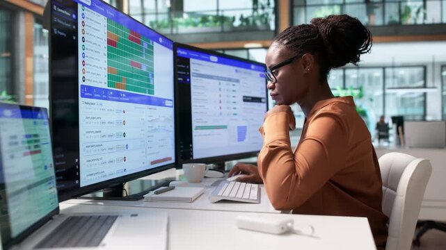 Data Engineer Monitors Complex ETL Pipeline Workflow Using Laptop