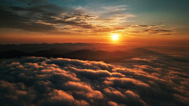 Golden sunrise illuminates rolling mountain peaks above a vast thick layer of white clouds during a beautiful clear morning light