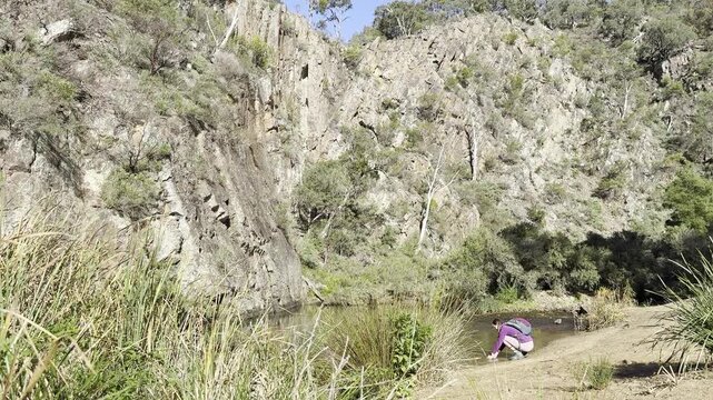 A girl hiker stands and admires the Werribee River during the challenging Werribee Gorge Circuit Walk &mdash; one of the best trails near Melbourne, Victoria, Australia.
