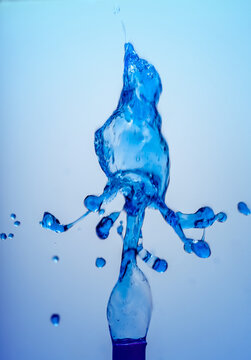 Macro photo of blue ice water splash on gradient background