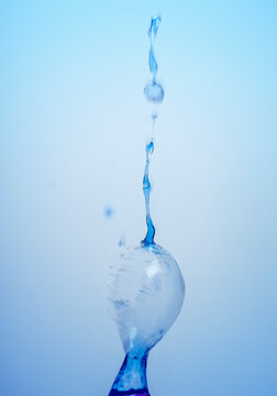 Macro photo of blue ice water splash on gradient background