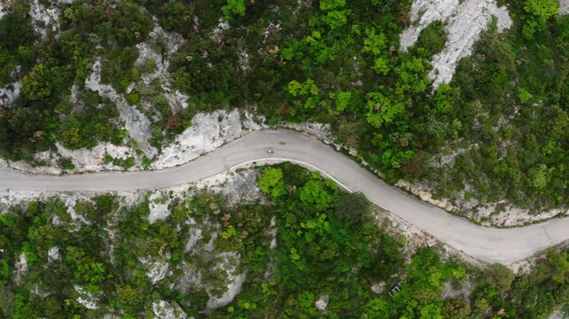 Top-down aerial view of cyclist riding on mountain road near &Egrave;ze, French Riviera, France