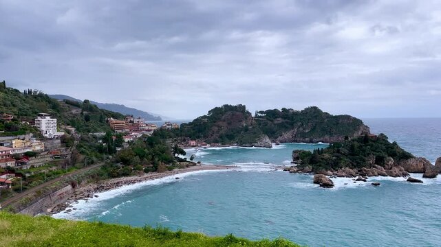 Scenic coastline view of Isola Bella and Taormina bay with turquoise sea in Sicily Italy