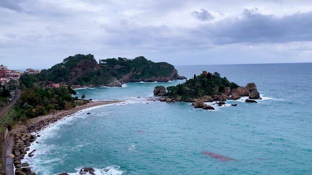 Scenic coastline view of Isola Bella and Taormina bay with turquoise sea in Sicily Italy