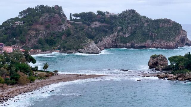 Scenic coastline view of Isola Bella and Taormina bay with turquoise sea in Sicily Italy