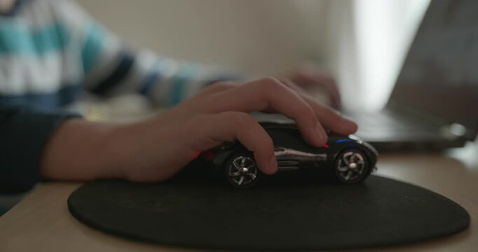 Close-up caucasian children hand use computer mouse controller. Boy use laptop. 4K 10-bit