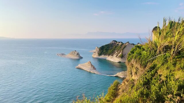 Scenic aerial view of Cape Drastis white sandstone cliffs and turquoise sea in Corfu, Greece