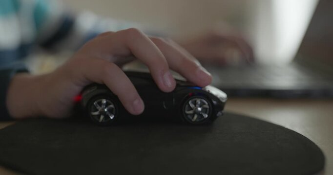 Close-up caucasian children hand use computer mouse controller. Boy use laptop. 4K 10-bit