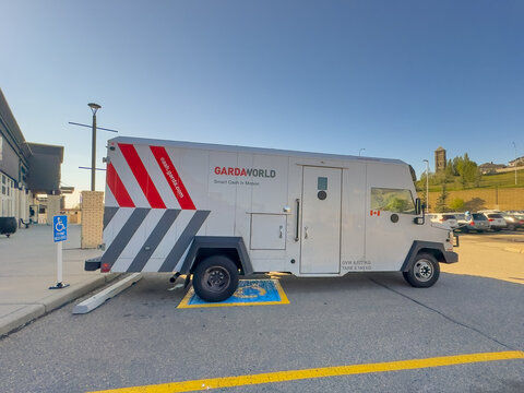 CALGARY, ALBERTA, CANADA. SEPTEMBER 10, 2026. GardaWorld armored security truck parked in a retail parking lot on a clear day.