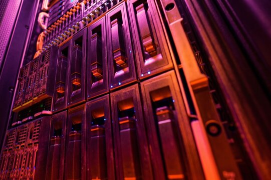 Rows of Server Cabinets in Dramatic Purple and Red Data Center Light