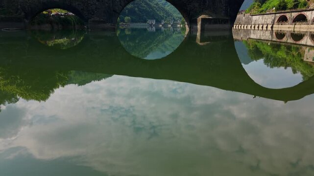 Stunning aerial footage flying under the medieval Ponte della Maddalena, also known as Devil's Bridge, in Tuscany, Italy