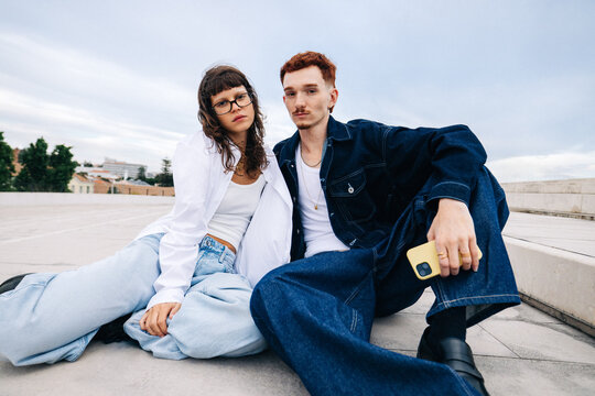 Young couple relaxed together on urban rooftop portrait