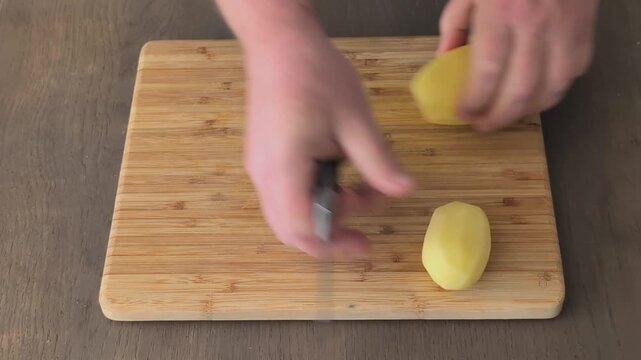 Cutting potatoes into small wedges in a kitchen for a cooking task