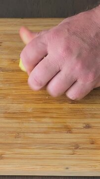 Peeling potatoes and cutting them into small slices in a kitchen at home