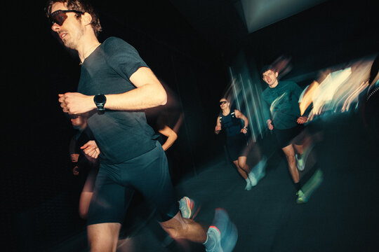 Group running with a run club during night training outdoors