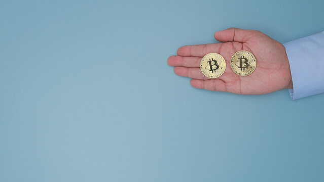 Confident investor hand holding gold crypto coin showing secure digital asset management for modern financial investment wealth