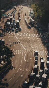 City streets filled with vehicles moving in different directions, showcasing urban traffic patterns and vibrant sunlight. Time-lapse, Seoul, South Korea
