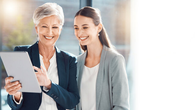 Senior mentor and young businesswoman celebrating success with tablet and blurred office background banner.