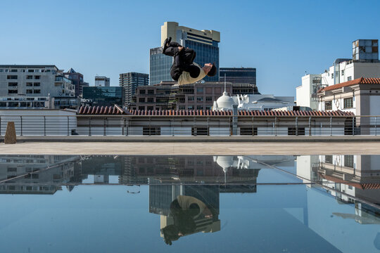 man doing a backflip in the city