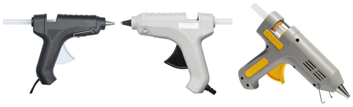 Three different hot glue guns isolated on a transparent background