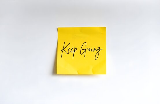 Bright Yellow Post It Note With Motivational Keep Going Message