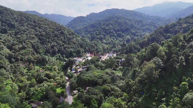 Flyover valley village Mai Kampong in dense jungle mountains, Thailand