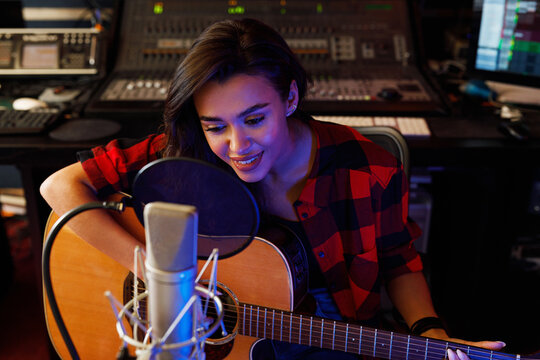 Portrait of a young female singer with guitar