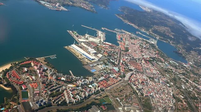 Aerial Spinning View taken from a jet cockpit of El Ferrol City, captured in a left turn while flying over the bay with a view of the city and shipyards.