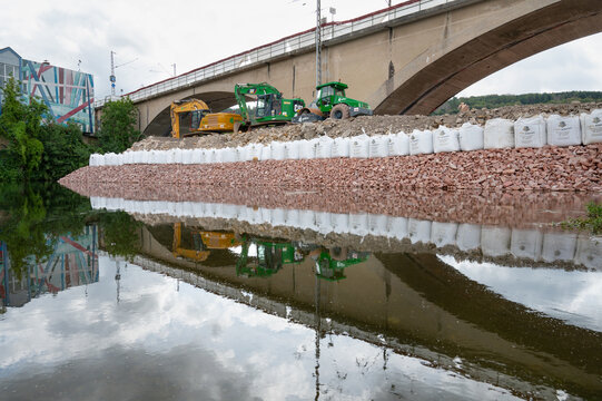 Construction site, excavators and road roller, temporary bank reinforcement, sandbags and crushed stone, bridge Wasserbillig, Luxembourg