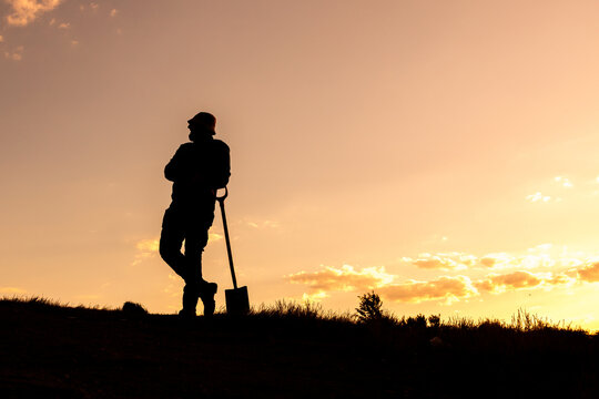 Waiting and Thinking, Silhouette with Shovel and Hat