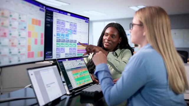 School Manager Reviewing Student Attendance Data On Laptop