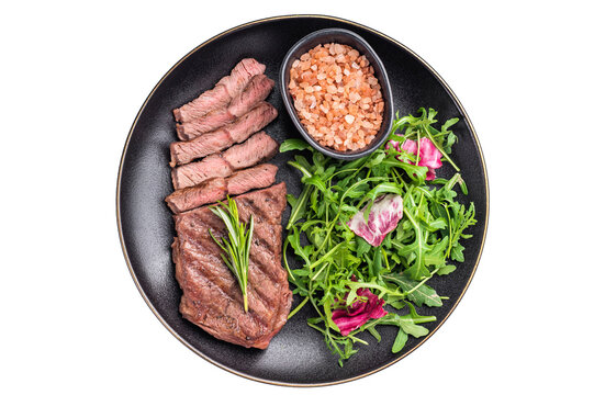 Grilled Top blade steak with salad, beef shoulder meat on a plate isolated on white background. top view