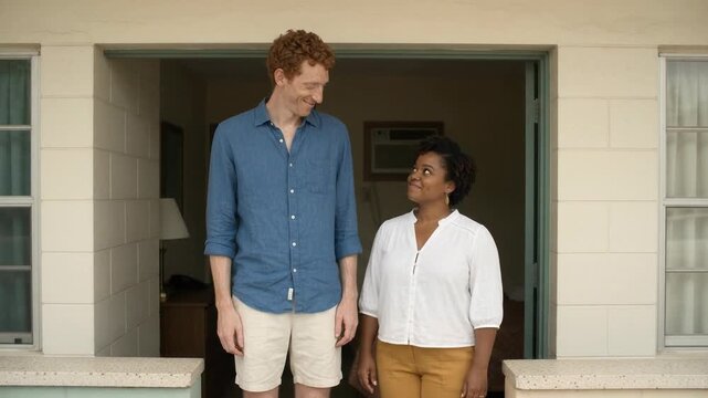 Very Tall Man Standing With Woman at Motel Room Doorway