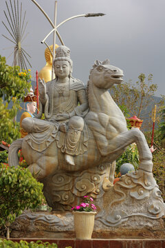Stone Guanyin statue sitting on lunar zodiac horse mount, traditional Asian astrology galloping stallion sculpture for swift career success