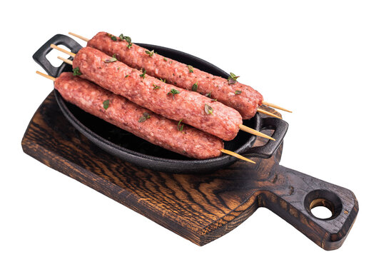 Raw Cevapcici skewers, Cevapi sausages from mince beef and pork meat isolated on white background. top view