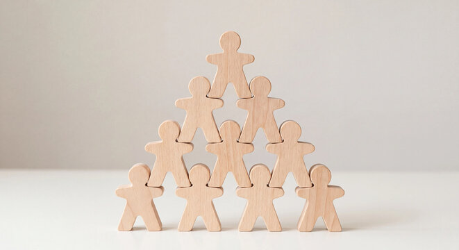 Wooden figurines stacked in pyramid shape teamwork leadership business concept photo