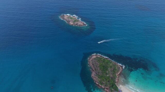 Aerial view of calm blue ocean water with distant tropical islands on horizon, Redang Island, Malaysia