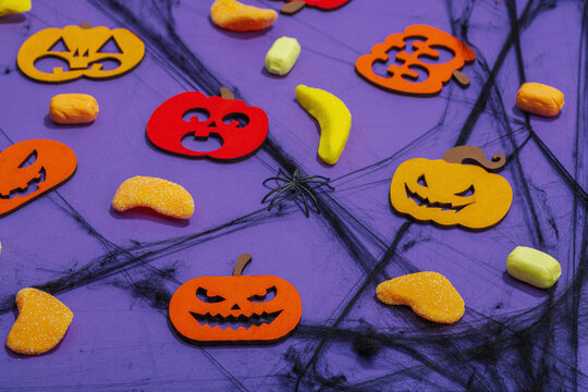 Funny Halloween background. Scary spider web, traditional fall pumpkins, bats and spiders