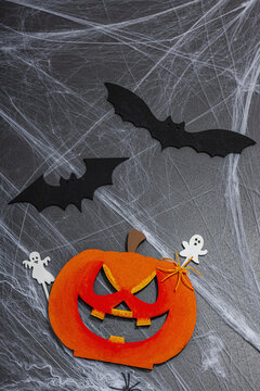 Traditional festive composition for Halloween party. Funny seasonal props, homemade autumn decor